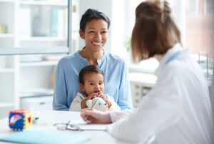 HBCD Study Participation - WOman holds her baby while speaking with a doctor